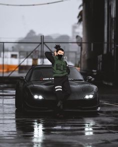 a person sitting on top of a car in the rain