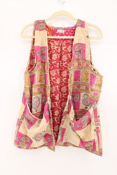 Our Blossom Vest is a simple way to add boho style to any outfit. Made from vintage saris, these beautiful kantha stitched cotton vests feature deep pockets and a minimalist design. This is a "one size" style. Approximately 33” length. Care Instructions: Hand wash and line dry for longest life. Disclaimer: The material used in this style is repurposed, vintage material. Small imperfections may be present. Fabrics may have small threads or holes in the layers. Small stains may be found. Embroidered Vest, Boho Vest, Repurposed Vintage, Jean Vest, Cotton Vest, Vintage Material, Kantha Stitch, Vintage Saris, Boho Diy