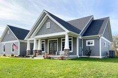 a house with gray siding and white trim