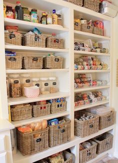 an organized pantry with wicker baskets, food and other items on shelving units