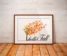 an orange tree with leaves blowing in the wind on a wooden floor next to a white brick wall