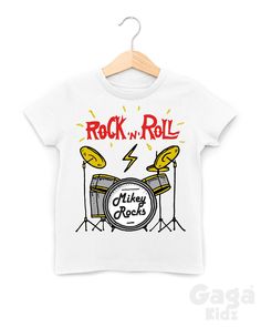 Kids 'custom name' rock 'n' roll drummer white t-shirt. Age / Size - Standard Universal Sizes * 0-3 Months / 6 - 12 lbs * 3-6 Months / 12 - 17 lbs * 6-12 Months / 17 - 24 lbs * 1-2 Years / Chest (to fit): 22 inch * 3-4 Years / Chest (to fit): 26 inch * 5-6 Years / Chest (to fit): 28 inch * 7-8 Years / Chest (to fit): 30 inch * 9-10 Years / Chest (to fit): 32 inch * 11-12 Years / Chest (to fit): 34 inch * Made from soft 100% cotton tees. Here at Gaga Kidz we're focused on producing high-quality, White Graphic Rock And Roll T-shirt, White Cotton Rock And Roll T-shirt, White Cotton T-shirt Rock And Roll Style, White Punk Top With Band Logo, Rock And Roll Band Logo T-shirt For Fans, Rock And Roll White T-shirt For Streetwear, White Rock And Roll T-shirt For Streetwear, White Rock And Roll T-shirt For Concert, White Music-themed T-shirt For Fans