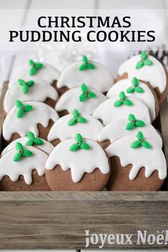 christmas pudding cookies in a wooden box with white icing and green sprinkles