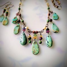 Necklace & Earrings set.  Loving the blue-greenhue of these Mexican turquoise raindrops, dangling with accents of tourmaline, mother of pearl, goldstone and African turquoise.  Suspended from my hand twisted, *Non-tarnish* bronze links.  Necklace is 17.5 inches long, and earrings dangle just shy of 1.5 inches below the earlobe. *The bronze chain is of excellent quality and has been treated to never tarnish and always remain the original color. Bohemian Jewelry With Teardrop Pendant And Dangling Beads, Bohemian Teardrop Pendant Jewelry With Dangling Beads, Green Teardrop Bohemian Jewelry, Bohemian Green Teardrop Jewelry, Artisan Jewelry With Green Dangling Beads, Green Artisan Dangle Jewelry, Artisan Green Dangle Jewelry, Artisan Teardrop Gemstone Beads Jewelry, Nature-inspired Jewelry With Dangling Beads For Gifts