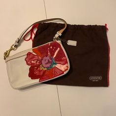 Coach White Leather Handbag With Beautiful, Colorful Flower. Comes With Original Protective Bag. Never Used. White Clutch Pouch With Dust Bag, Coach Bags With Removable Pouch As Gift, Designer Bags With Zipper Pouch For Gifts, Designer Bags With Zipper Pouch As Gift, Coach Rectangular Zipper Pouch, Coach Clutch With Removable Pouch, Rectangular Coach Zipper Pouch, Designer Coach Bags For Spring, Designer White Shoulder Bag Clutch