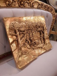 a gold plate sitting on top of a white chair