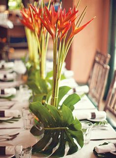 there is a long table set with flowers and place settings for dinner guests to enjoy