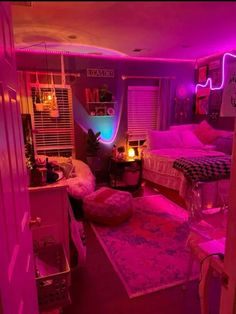 a room with two beds and pink lighting