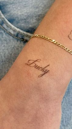 a woman's arm with a tattoo on it that says, faith in cursive writing