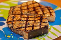 two pieces of grilled meat sitting on top of a plate