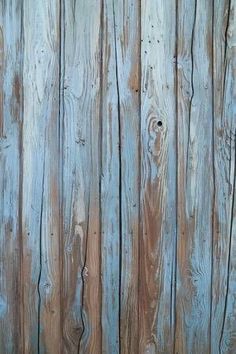 an old wooden fence with peeling paint on it