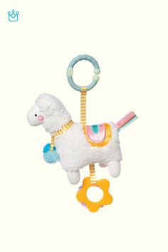 a white llama toy with a pacifier attached to it's back end