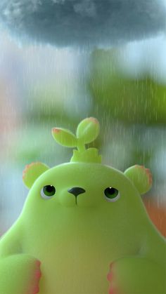 a green stuffed animal sitting in the rain