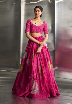 This exquisite ensemble features a hand-embroidered lehenga with intricate nakshi, dabka, and threadwork, extending elegantly across the blouse, lehenga, and dupatta. The detailed craftsmanship and shimmering gold embroidery infuse the outfit with opulence and sophistication, making it perfect for any special occasion. Pink Tissue Silk Sharara With Mirror Work, Pink Sharara With Mirror Work In Tissue Silk, Pink Silk Sets With Mirror Work, Pink Organza Sets For Navratri, Pink Tissue Silk Choli With Mirror Work, Pink Chanderi Dress With Mirror Work, Pink Organza Anarkali Set With Unstitched Blouse, Pink Organza Lehenga With Unstitched Blouse, Festive Pink Lehenga In Tissue Silk