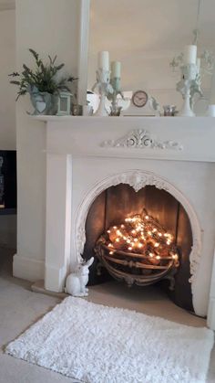 a living room with a fire place filled with candles