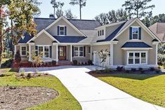 a large house with lots of windows in the front yard