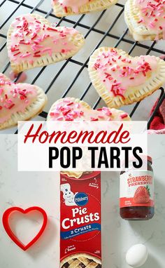 homemade pop tarts with pink frosting and sprinkles are on a cooling rack