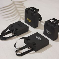 three black boxes sitting on top of a table next to each other with straps around them