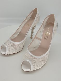 A pair of a fairy bridal pumps for the most beautiful day in your life.Handmade real leather peep toe pumps in pearl white ,embellished with swarovski crystals all over the elegant ivory lace and a sparkling trim that hugs the  heel.Leather sole,leather lining,open toe to show off pedicure.Comfortable and customized fit.Heel 10,5 cm.You can match it with an assorted clutch for a unique look.You can find the clutch in another listing .Price is only for the heels.If you order together  there is a discount of the total Lace Bridal Shoes, Bridal Pumps, Lace Pumps, Heels White, Bridal Heels, Shoes Wedding, Womens Wedding Shoes, Lace Bridal, Ivory Lace