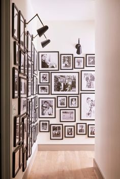 the hallway is decorated with black and white photos