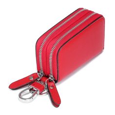 a red purse with two zippers and a keychain