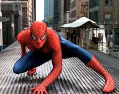 the amazing spider - man is on his knees and arms stretched out in front of him