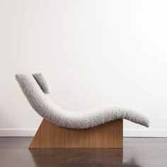 a chair that is sitting on top of a wooden block