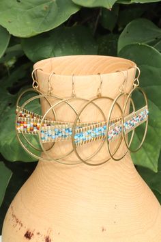 Add a vibrant touch to your outfit with these colorful beaded hoop earrings. Handmade with love, these hoops are crafted using golden brass and high quality seed beads in a delightful array of colors. The intricate beadwork adds a playful and eye-catching element to these earrings, making them a must-have for any jewelry lover. Lightweight and comfortable to wear, these hoops are perfect for adding a pop of color to your everyday style or dressing up for special occasions. They also make a wonde Adjustable Hoop Beaded Earrings With Colorful Beads, Small Hoop Beaded Earrings With Tiny Beads For Festival, Multicolor Metal Hoop Jewelry, Festival Small Hoop Earrings With Tiny Beads, Multicolor Dangling Beaded Brass Earrings, Bohemian Hoop Beaded Earrings With Colorful Beads, Bohemian Tiny Beads Hoop Earrings, Multicolor Brass Jewelry With Dangling Beads, Gold Bohemian Hoop Earrings With Dangling Beads