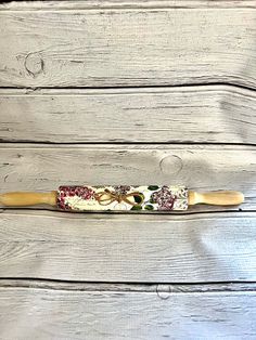 a baseball bat sitting on top of a wooden floor next to a wall with wood planks