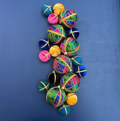 a group of multicolored christmas ornaments on a blue surface