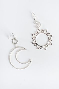 Shine bright with our Solar Love Earrings! These celestial-inspired earrings feature a small sun and big crescent moon drop on one earring and a small moon and big sun drop on the other. Available in silver and gold with fishhook backs. They are the perfect accessory to elevate your look and are lightweight and lead and nickel compliant. Cheap Silver Earrings With Sun And Moon Design, Silver Sun And Moon Design Drop Earrings, Adjustable Sterling Silver Sun And Moon Earrings, Silver Earrings With Sun And Moon Design - Symbolic, Bohemian Sun And Moon Sterling Silver Earrings, Shine Bright, Crescent Moon, Fish Hook, New Arrival Dress