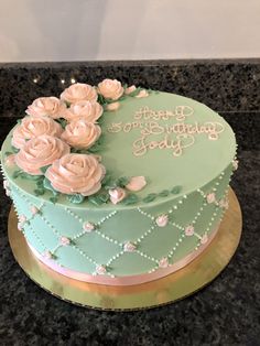 there is a green cake with white flowers on it