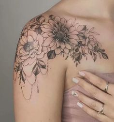 a woman's shoulder with flowers on it