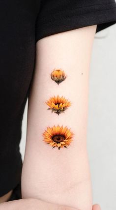 three sunflowers on the left side of the arm