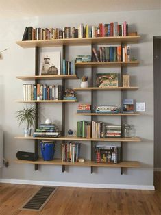 a living room filled with furniture and bookshelves covered in lots of different types of books