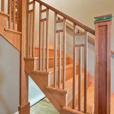 a wooden stair case next to a glass door