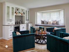 a living room filled with furniture next to a window