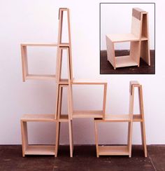 a stack of wooden shelves sitting on top of a floor next to a white wall