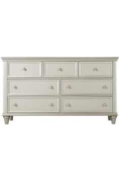 a white dresser with six drawers and two doors