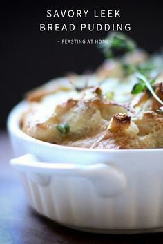 a close up of a casserole dish on a table with the words savory leek bread pudding feasting at home