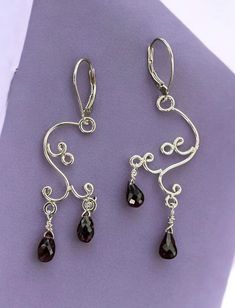 Elegant chandelier earrings crafted with stunning rhodolite garnet gemstones set in sterling silver. Lever back Silver Gemstone Chandelier Drop Earrings, Silver Gemstone Drop Chandelier Earrings, Elegant Sterling Silver Chandelier Earrings With Gemstones, Handmade Amethyst Chandelier Earrings, Handmade Elegant Amethyst Chandelier Earrings, Elegant Garnet Teardrop Earrings, Elegant Amethyst Chandelier Earrings For Gift, Handmade Elegant Garnet Earrings, Elegant Silver Gemstone Chandelier Earrings