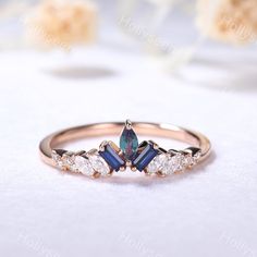 an image of a ring with three stones in it on a white tablecloth background