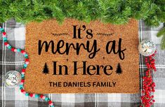 a christmas door mat that says it's merry at in here the daniels family