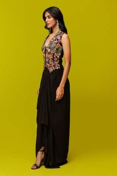 Black waistcoat with multicolor thread embroidery in floral cutwork pattern. Paired with draped skirt. - Aza Fashions Designer Sleeveless Dresses With Dori Work, Sleeveless Dresses With Dori Work, Designer Front Open Dresses With Intricate Embroidery, Sleeveless Embroidered Dress For Reception, Fitted Sleeveless Sets With Multicolor Embroidery, Front Open Dresses For Reception, Embroidered Front Open Dress For Reception, Festive Sleeveless Anarkali Embroidered Dress, Designer Sleeveless Dresses With Floral Embroidery