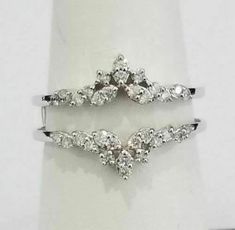 two white gold rings with diamonds on them