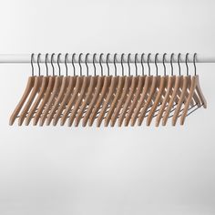 several wooden clothes hangers on a white wall