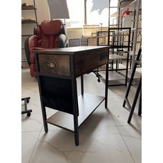 a chair sitting next to a wooden table on top of a tile floor in front of a window