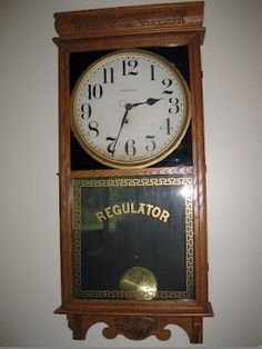 an old fashioned clock with the word regulator on it's front and sides