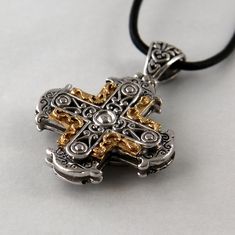 Our cross Sphere is influenced by Byzantine culture and therefore rich in ornaments. It is handmade in silver and 18 k gold, the dimensions are 3,0 cm in width, 3,0 cm in height. Height including the loop is 4,5 cm. Our pendants and crosses don't come with a chain. White Gold Byzantine Jewelry Hallmarked, Luxury White Gold Cross Necklace, Yellow Gold Cross Necklace With Large Pendant, Formal Spiritual Crucifix Jewelry, Luxury Cross Pendant Necklace, Luxury Crucifix Cross Necklace For Formal Occasions, Handmade White Gold Cross Jewelry, Hallmarked Byzantine Sterling Silver Jewelry, Byzantine Sterling Silver Hallmarked Jewelry