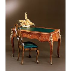 an antique desk and chair with flowers on it